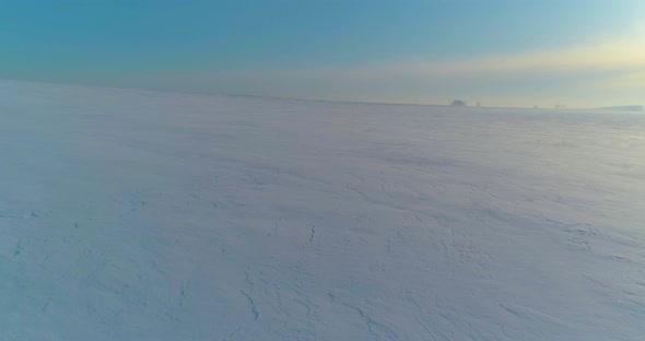 Aerial View of Cold Winter Landscape Arctic Field Trees Covered with Frost Snow Ice River and Sun