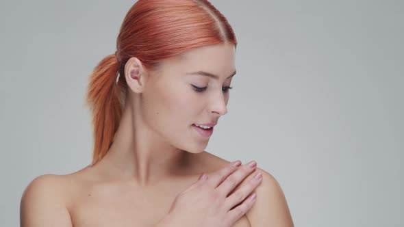 Studio portrait of young, beautiful and natural redhead woman. Beauty concept.