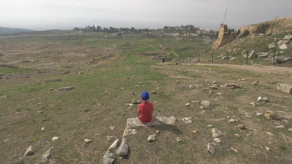 A Steadicam Shot of a Boy Looking at the Ruins of Ancient Hierapolis