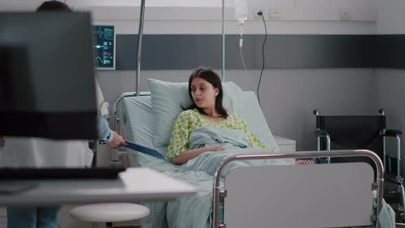 Practitioner Specialist Checking Hospitalized Sick Woman Resting in Bed