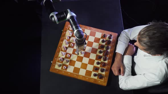 Man Playing Chess with a Robot, the Confrontation Between Man and Artificial Intelligence