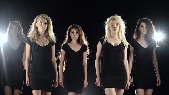 Model Gait of Beautiful Girls. Black Background. Slow Motion