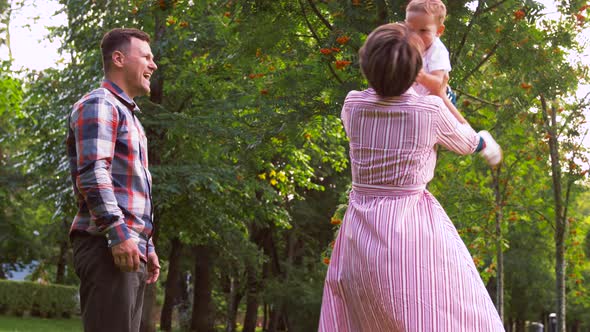 Happy Family Playing at Summer Park