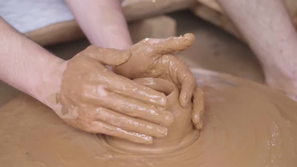 Hands Makes Clay Pottery On A Spin Wheel