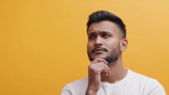 Indian Guy Looking Up And Thinking  Concept Of Thinking Of An Idea Or Solution