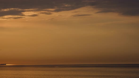 Romantic colorful sunset at the sea. Against the background of the sea, the sun goes down