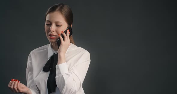 Young Manager Woman in Business Suit Has a Business Talk Via Mobile Phone Work with Objections Sells