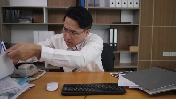 Businessman office worker typing at the laptop computer and many work