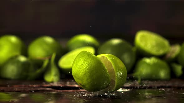 Super Slow Motion Fresh Lime Falls on the Table and Splits in Two