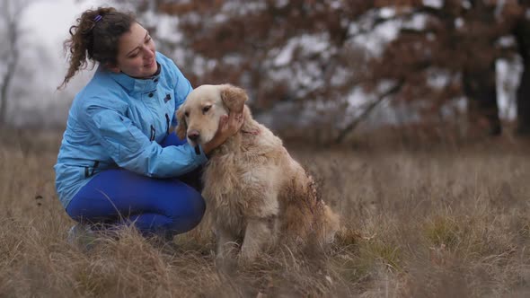 Cheerful Woman Caressing Her Labrador Retriever