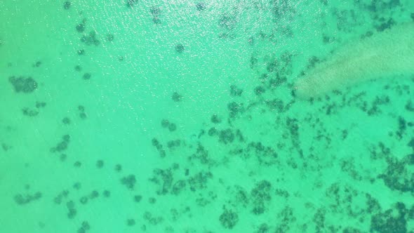 Aerial above landscape of beautiful tourist beach adventure by aqua blue ocean with white sandy back