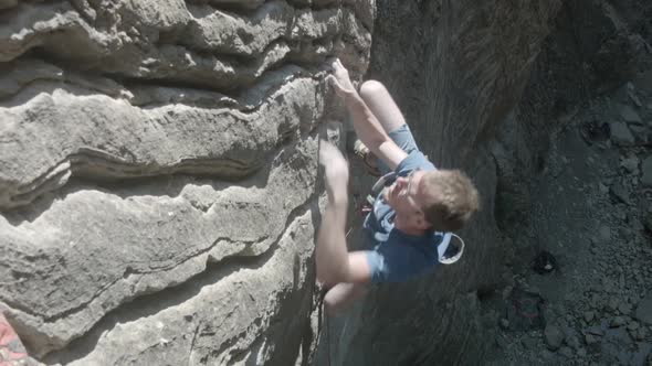 A man rock climbing up a mountain.