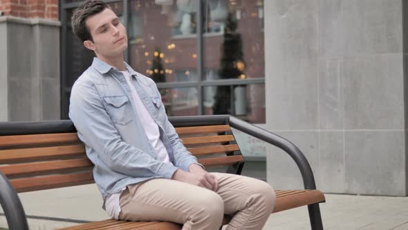 Young Man Coming and Sitting on Bench