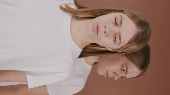 Vertical Portrait of Twins Posing for Camera