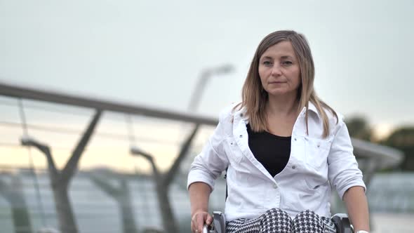 Handicapped Woman Riding Wheelchair on Footbridge