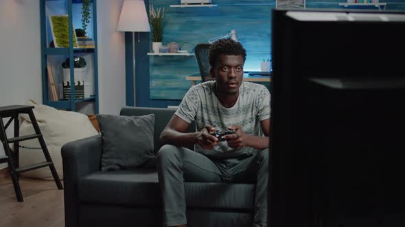 Man Playing Video Games on Tv Console with Controller