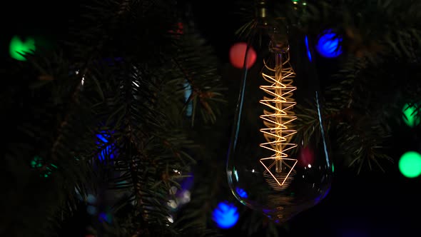 Light Bulb Turns on and Off on the Background with Garlands. Close Up