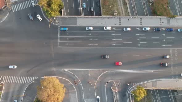 Caring on a big busy crossroad, drone topdown timelapse