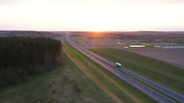 Cargo Truck With Cargo Trailer Driving On Highway At Sunset Aerial View