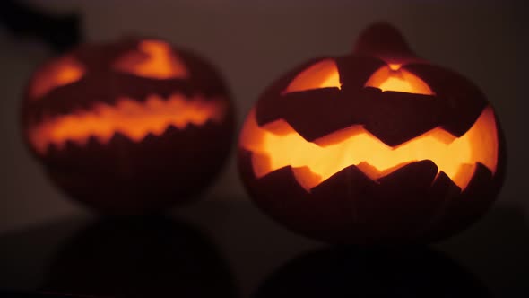 sinister pumpkins on Halloween, bat in the background