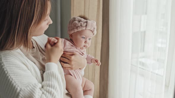 Young Mum Holding Baby