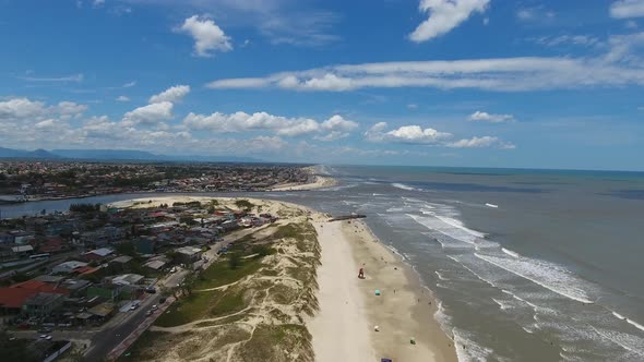 Aerial scene of a beach in the summer in south of Brazil. Blue sky with clouds.