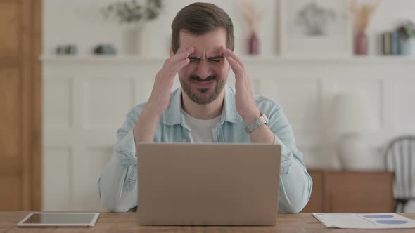 Young Man Having Headache While Working on Laptop