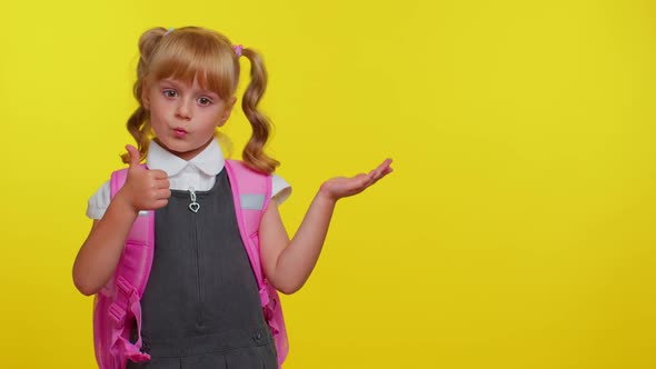 Smiling Cute Schoolgirl Kid with Backpack Looking at Copy Space for Promotional Content Holding Hand