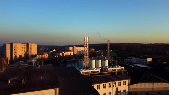 Aerial view of a drone flying over the beer production plant, several rows of tanks. 