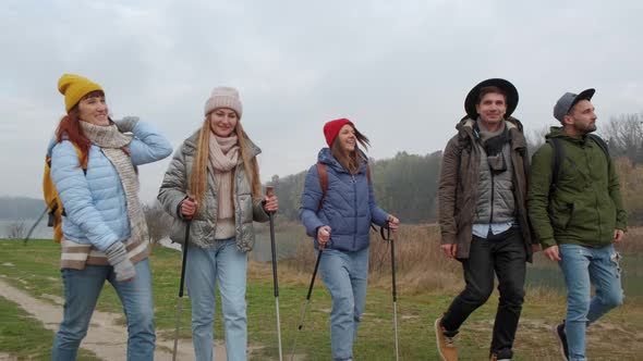 Group of Hikers Walking on a Mountain at Autumn Day