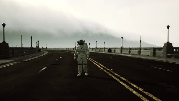 Astronaut Walks in the Middle of a Road