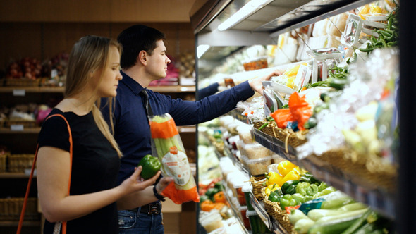 Young Couple Choosing Fresh Vegetables