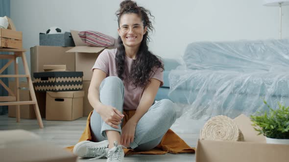 Portrait of Beautiful Asian Girl Sitting in New Flat Holding Key Smiling