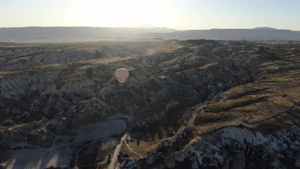 Hot air balloons flying over the valleys of Cappadocia near Goreme, Turkey