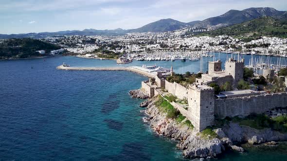 View from drone on full of yachts Bodrum harbour and ancient Kalesi castle in Mugla in Turkey