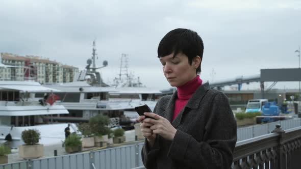 Woman Sms Texting Using App on Smartphone in Port
