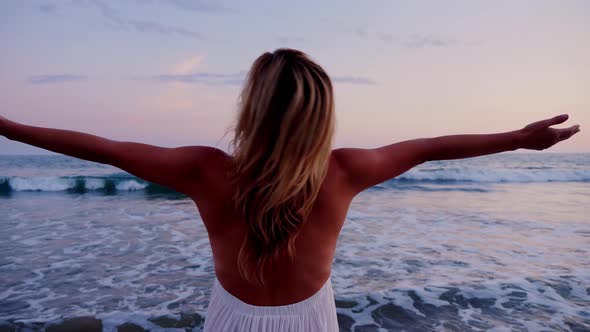 Attractive Woman Enjoying The Beach At Sunset