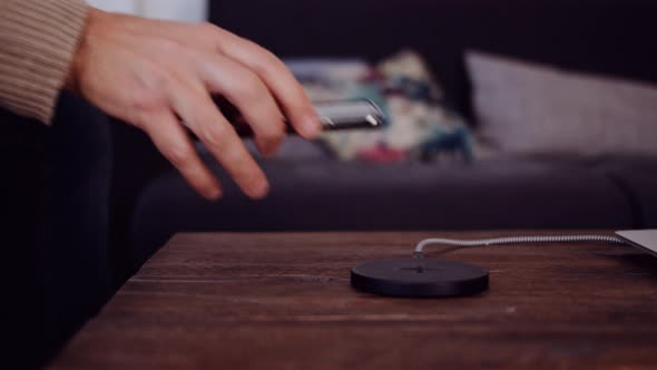 Slow motion shot of a man charging a smartphone with a power bank