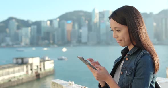 Woman using mobile phone in city 