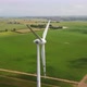 Drone Shot Circling Around a Large Wind Turbine in Open Green Fields - VideoHive Item for Sale