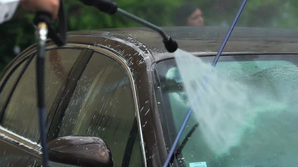 Male Business Driver Washing Car With Water, Taking Care of Expensive Vehicle