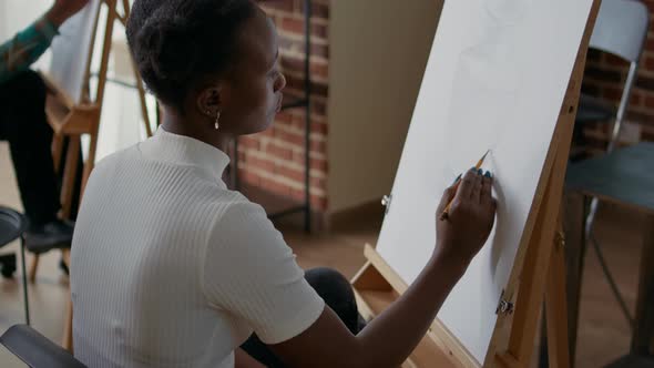 African American Woman Drawing Object Model on Canvas and Easel