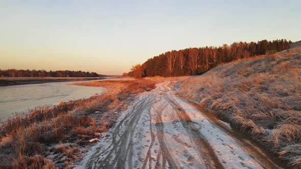 The Grass and the Road By the River are Covered with White Frost Aerial View