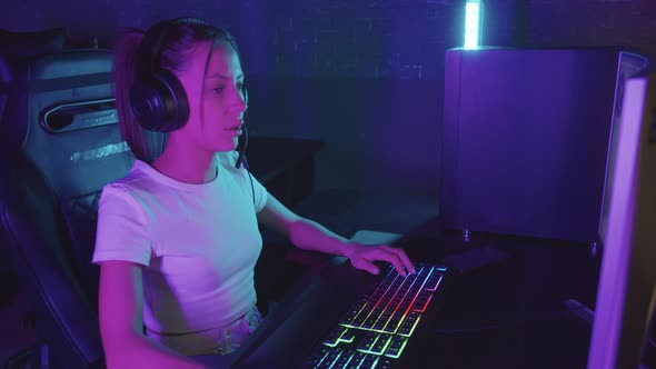 Girl Gamer Sits at the Computer in the Gaming Club and Playing  Loses the Game