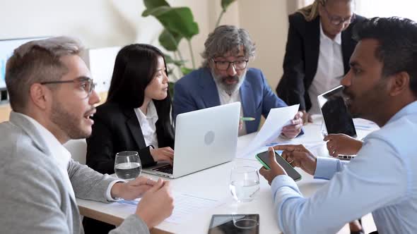 Multiracial business people working inside bank meeting room