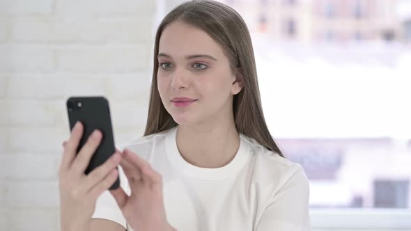 Portrait of Focused Young Woman Using Smartphone 