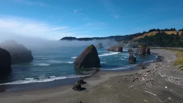 AERIAL: Push forward towards Oregon's rock formations and the blue ocean.