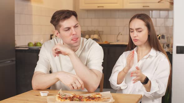 Beautiful Caucasian Family Ordered Pizza Home. Young Couple Got a Pizza and Left the Table.