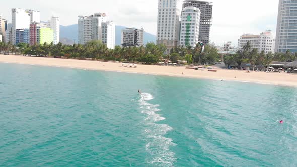 Aerial View of the City Beach and Active People Practicing Kite Surfing and Windsurfing. Kitesurfing