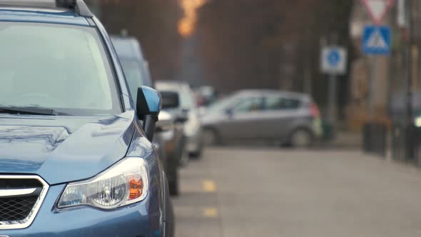 Cars Parked in a Row on a City Street Side